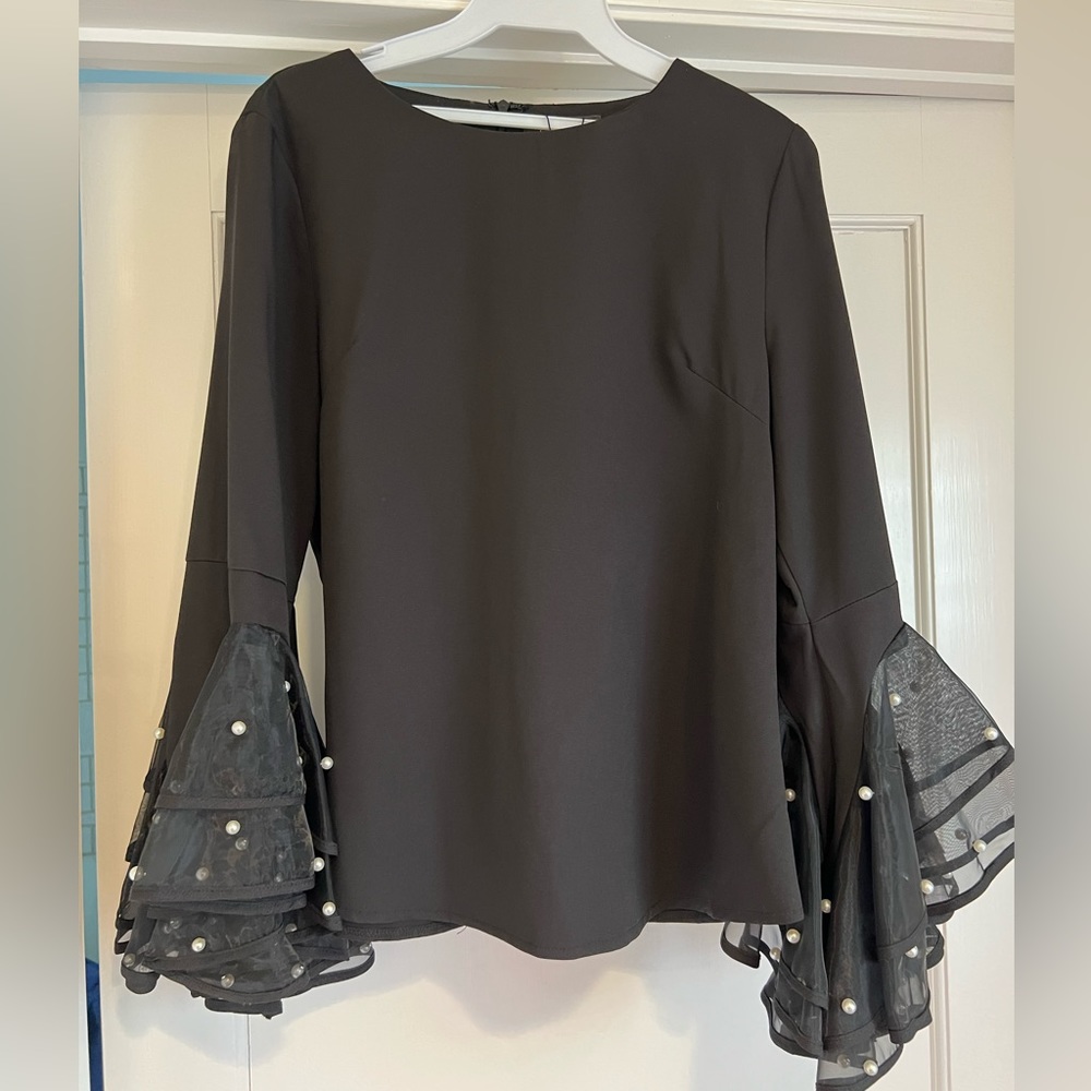 Black top with ruffle pearl sleeve. Size Medium. NWT.